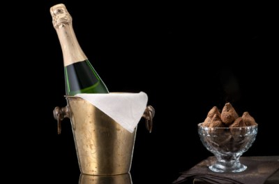 bottle of champagne and dish of chocolate truffles