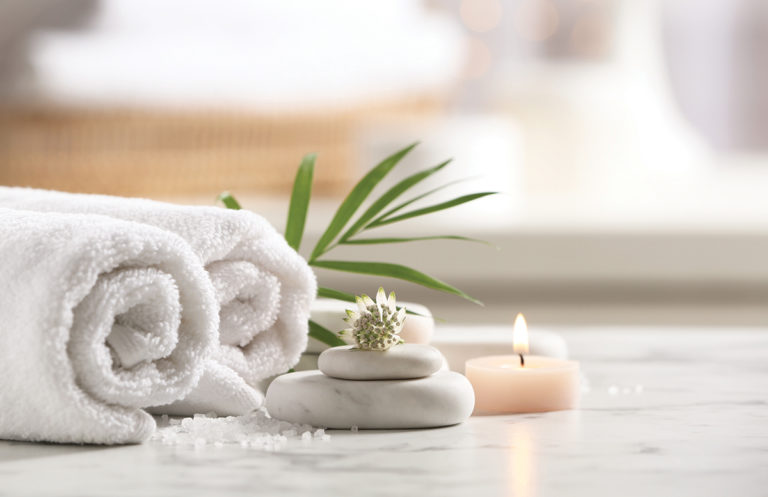 spa towels with stones and candles