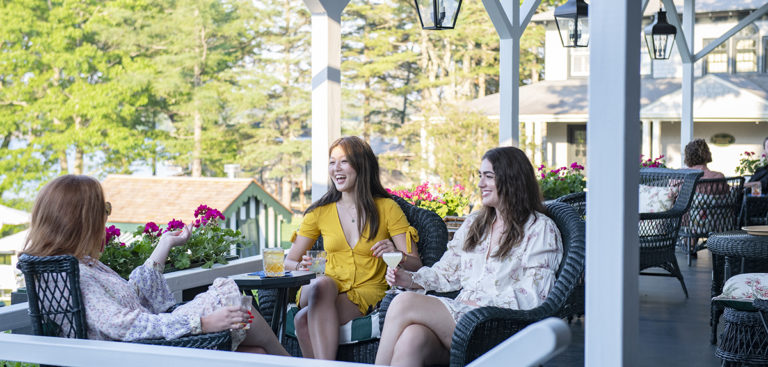 young women on porch enjoying cocktails