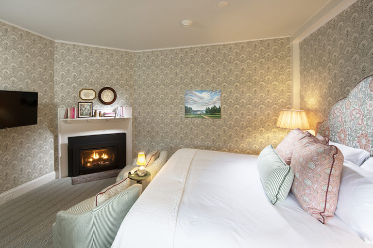 premier garden view room showing bed and fireplace