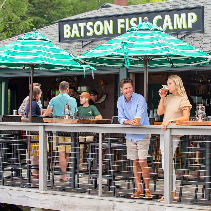 Batson Fish Camp guests on deck drinking and chatting