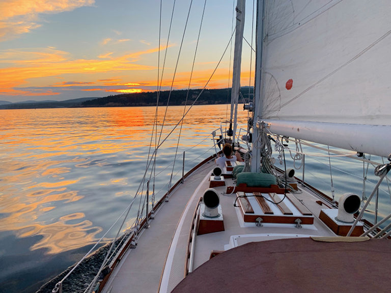 sailboat heading toward sunset